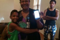 When her son William started taking public transportation to school, Lashunda Dean downloaded a tracking app on her cellphone. She shows off the app while her older son and the family cockatiel look on.
Credit: Mallory Falk / WWNO