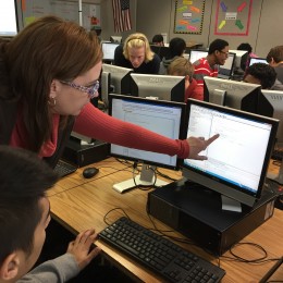 Hoover High School computer science teacher Jill Westerlund helps a student with Java, which she calls an "unforgiving" language. Credit: Dan Carsen/WBHM.