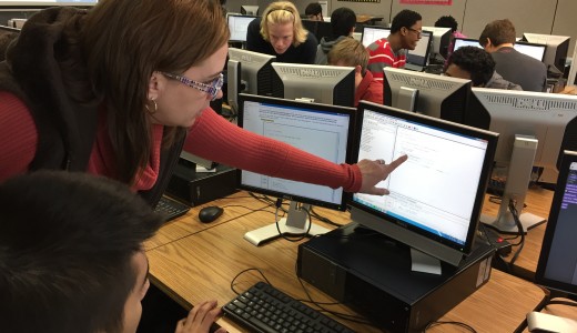 Hoover High School computer science teacher Jill Westerlund helps a student with Java, which she calls an "unforgiving" language. Credit: Dan Carsen/WBHM.