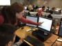 Hoover High School computer science teacher Jill Westerlund helps a student with Java, which she calls an "unforgiving" language. Credit: Dan Carsen/WBHM.